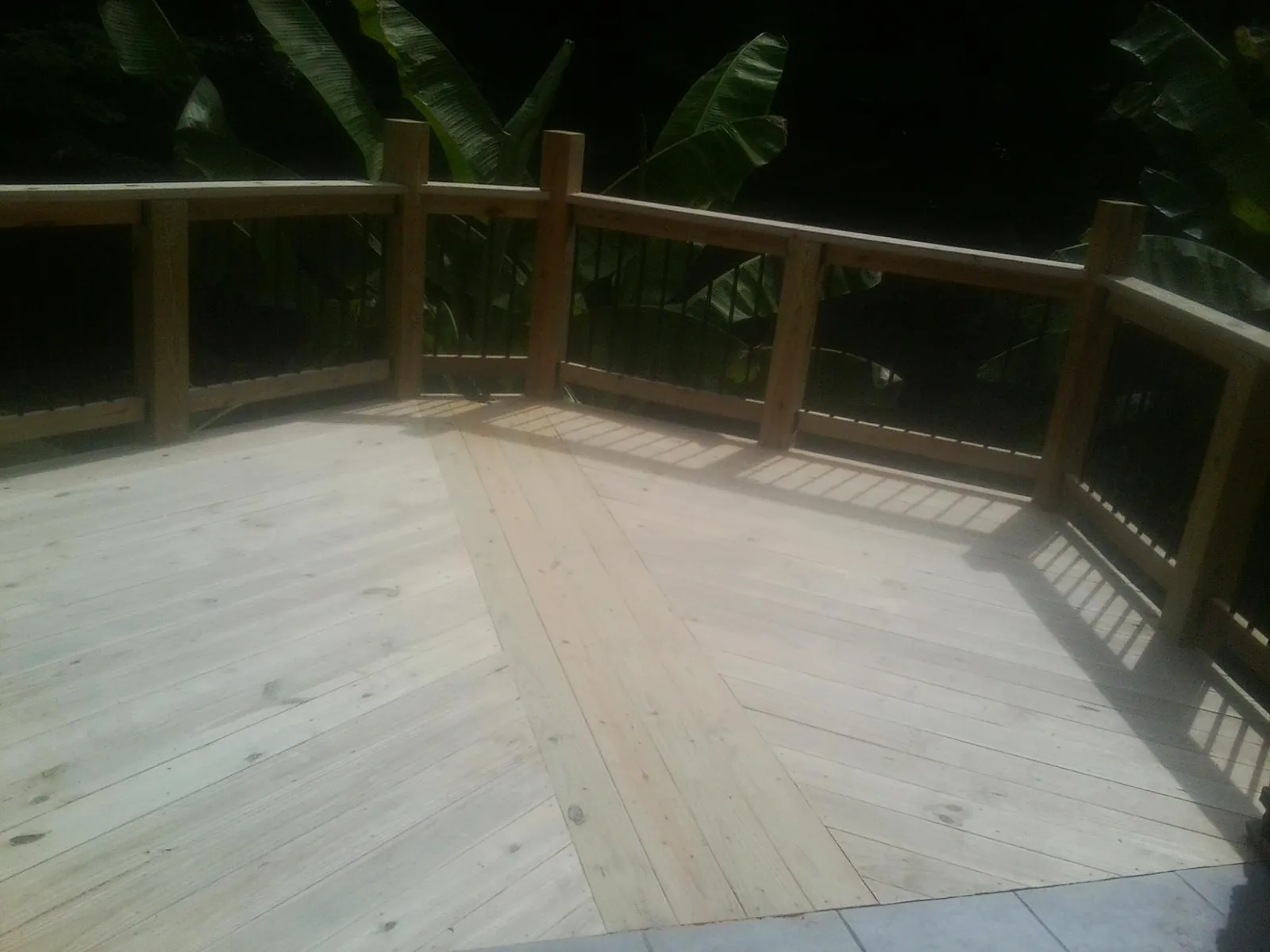 New wood deck and railing built off the back of a home in Hillsboro